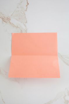 an orange piece of paper sitting on top of a white counter