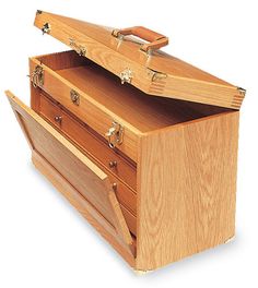 a wooden chest with two drawers on the front and one drawer open to show it's contents