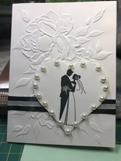 a wedding card with an image of a bride and groom in a heart - shaped frame