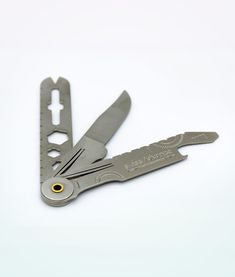 a swiss army knife is open on a white surface