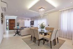 a dining room table surrounded by beige chairs