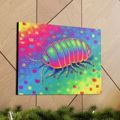 a colorful painting of a bug on a canvas next to christmas tree branches and decorations