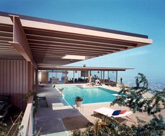 an outdoor swimming pool next to the ocean