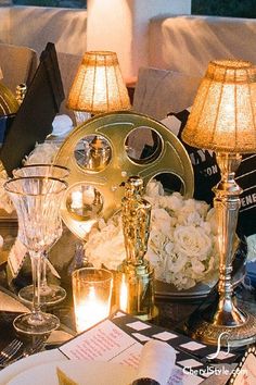 a table topped with lots of different types of candles and vases filled with flowers