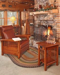 a living room filled with furniture and a fire place next to a stone fireplace covered in logs