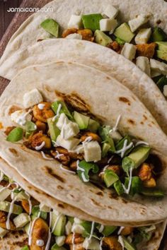 three tortillas with chicken, avocado and cucumber on top