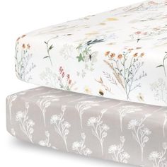 two sheets with flowers on them sitting next to each other