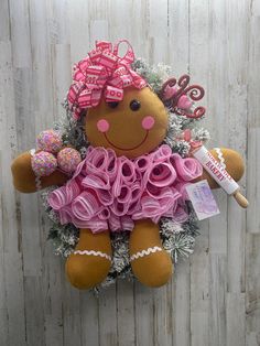 a stuffed teddy bear with pink bows and decorations