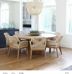 the dining room table is surrounded by wicker chairs