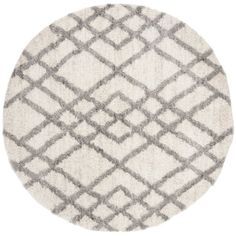 a round rug with grey and white patterns