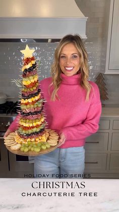 a woman holding a platter with food on it and the words holiday food series christmas charcuterie tree