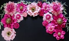 pink paper flowers arranged on black background