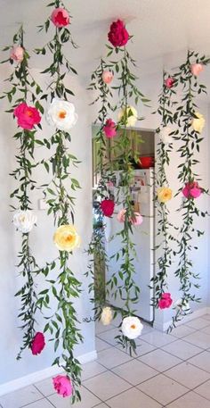 flowers are hanging from the ceiling in front of a refrigerator