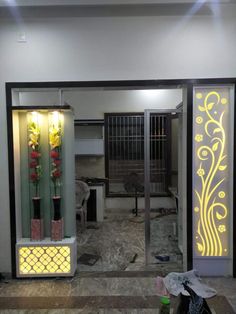 the entrance to an office building with flowers in vases on the wall and behind glass doors