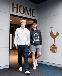 two young men walking out of a building