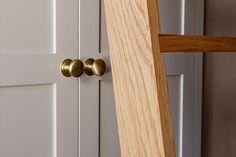 a close up of a wooden door handle on a white and wood door with two doors