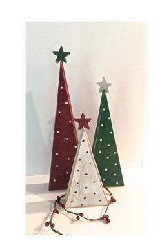 two small wooden christmas trees sitting next to each other