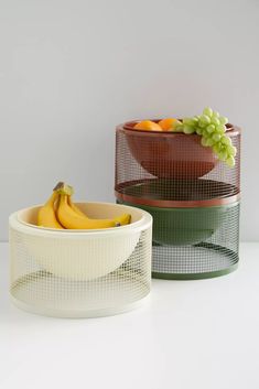 three bowls with fruit in them sitting on a white counter top next to each other