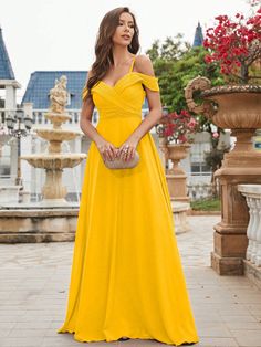 a woman in a yellow dress posing for the camera with her hand on her hip