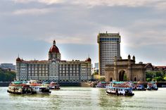 several boats floating on the water in front of buildings