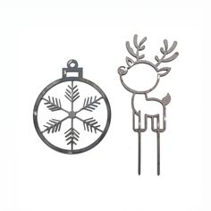 a metal ornament with a reindeer on it next to a christmas ornament