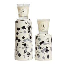 two white and black vases sitting next to each other