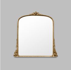 an ornate gold framed mirror against a gray background