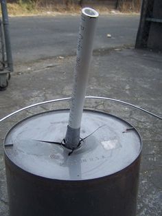 a metal pole sticking out of the top of a trash can