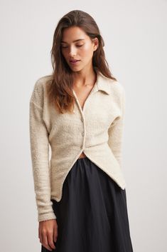 This sweater features a structured, slightly stretchy material and a form fit. It has a classic collar and a v neckline. Our sweater features button closures down the front. Fitted V-neck Sweater With Seamless Collar, Fitted Knit V-neck Polo Sweater, Fitted V-neck Knit Polo Sweater, Classic Cream V-neck Long Sleeve Sweater, White V-neck Polo Sweater For Fall, Cream Fitted Button-up Sweater, Fitted Cream Button-up Sweater, Elegant V-neck Knit Polo Sweater, Cream V-neck Sweater With Buttons