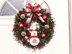 a christmas wreath with a snowman on it