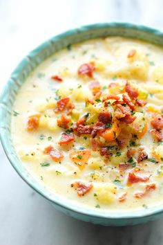 a blue bowl filled with soup on top of a table