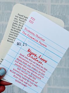 a person holding up a piece of paper that has been printed on it with the words happy new christmas