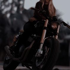 a woman sitting on top of a motorcycle