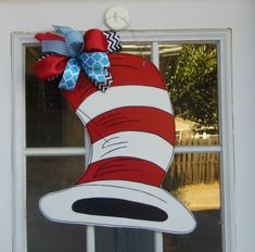 the cat in the hat door hanger is hanging outside