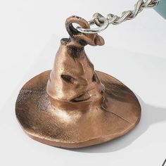 a harry potter's hat on top of a saucer with a chain attached to it