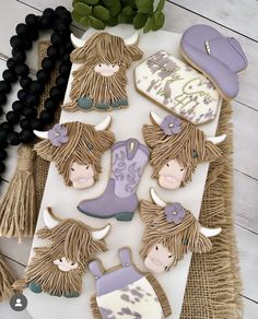 decorated cookies are arranged on a table with beads and tassels around them, including cowgirl's boots