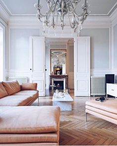 a living room filled with furniture and a chandelier