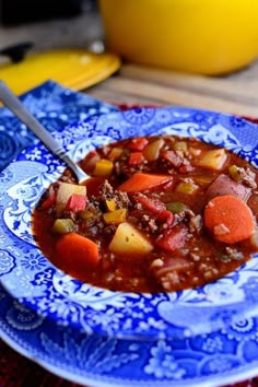 a blue and white plate topped with soup