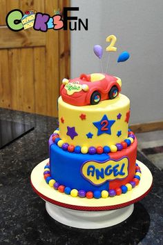 a birthday cake decorated with a car and stars