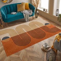 a living room with a blue couch and orange rug