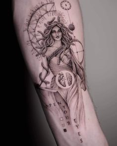 a woman's arm with a clock and compass tattoo on the left inner arm