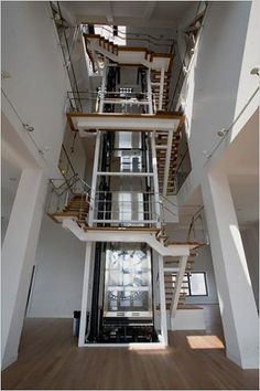 the inside of a building with multiple floors and balconies on each floor, looking up