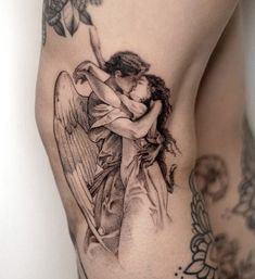 an angel tattoo on the side of a woman's thigh