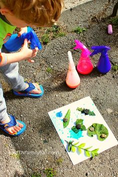 a little boy playing with toys on the ground