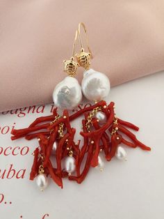 Statement earrings made of: - Natural Coral branches, red color; - Baroque Pearl Coins (14 mm), white color; - Gold plated 925 Sterling Silver hookswith little turtle. Lenght : 7 cm / 2,76 inches * SHIPPING * Your order will be shipped within 1-3 business days from your purchase. You can choose between 2 shipping methods: STANDARD MAIL (NOT TRACEABLE) It is a cheap and fast shipping method, but NOT TRACEABLE. Chapeau Atelier is not responsible for any postal disruptions, delays or losses. REGIST Natural Coral, Beading Projects, Baroque Fashion, Cluster Earrings, Sacred Heart, Red Coral, Baroque Pearls, Heart Earrings, Statement Earrings