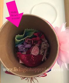 a bowl filled with lots of assorted items on top of a white counter next to a pink flower