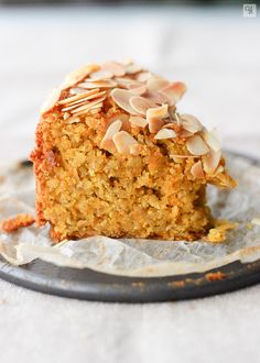 a piece of carrot cake with almonds on top