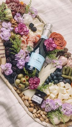 a platter filled with cheese, olives and flowers