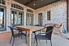 a table and chairs are on the outside patio with sliding glass doors that lead to an outdoor living area