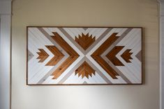 a wooden art piece hanging on the wall